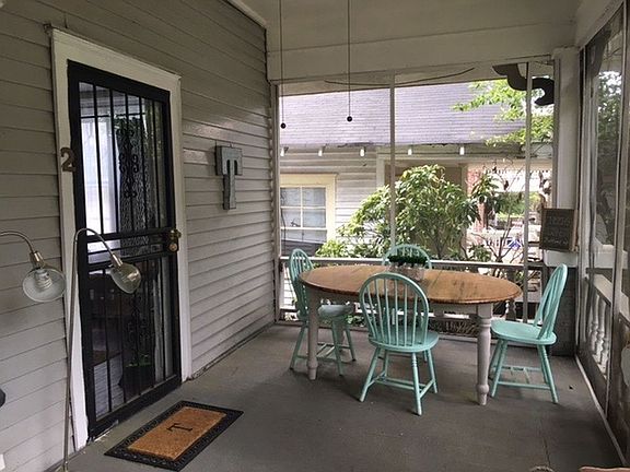 Screened in front porch. Perfect for a cute table or desk overlooking front yard garden.