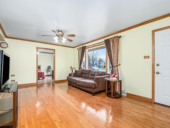 Large Living Room with Beautiful Hardwood Floors and Matching Crown Molding