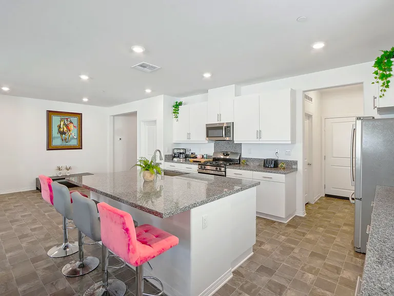 Stylish kitchen island with high chairs, perfect for casual meals and lively conversations!