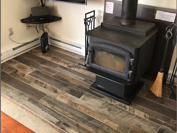 Newly renovated TV and fireplace area on middle floor living area.