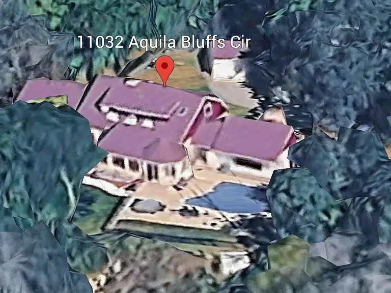 Overhead shot of property with pool and massive patio around pool with fire element.