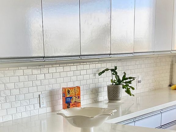 Newly updated white quartz kitchen with two stools at the counter for a fabulous work or morning coffee retreat space.