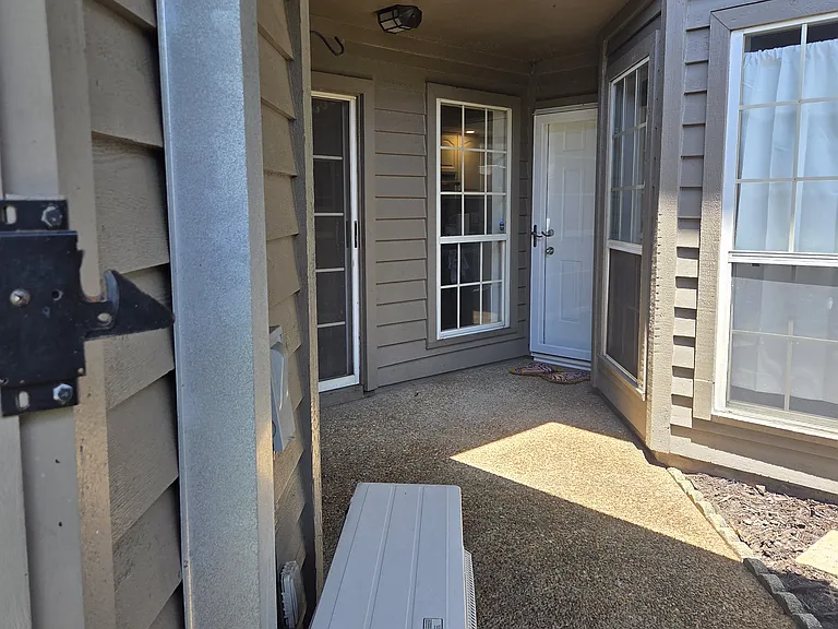 Outdoor Foyer Area. Garage AC unit to left. Out of frame to the right is whole home water filtration unit.