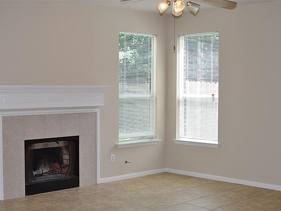 The Living Room is open to the kitchen. Tile floors for easy cleaning. Charming gas fireplace adds to the appeal of this room. The pool is steps off the backdoor.
