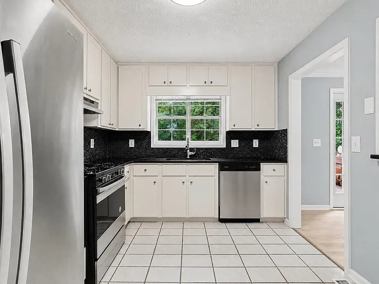Granite countertops and stainless steel appliances.