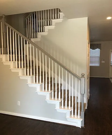 Brand new elegant stair carpet highlights spindle stair rails leading to the custom wood floors and large bedrooms.