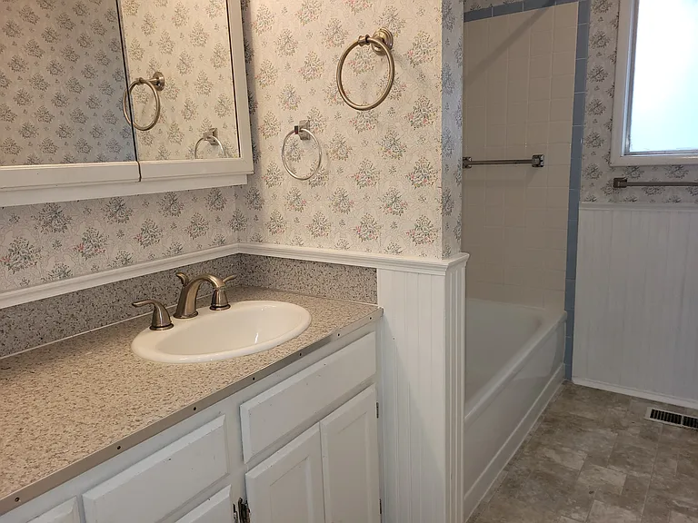 In the front of the house: full bathroom with new flooring, new toilet, freshly painted