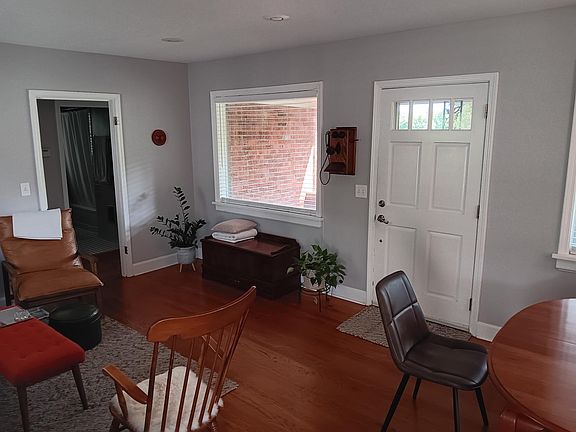 Living room from Back door looking at front door on right and back of the house on the left