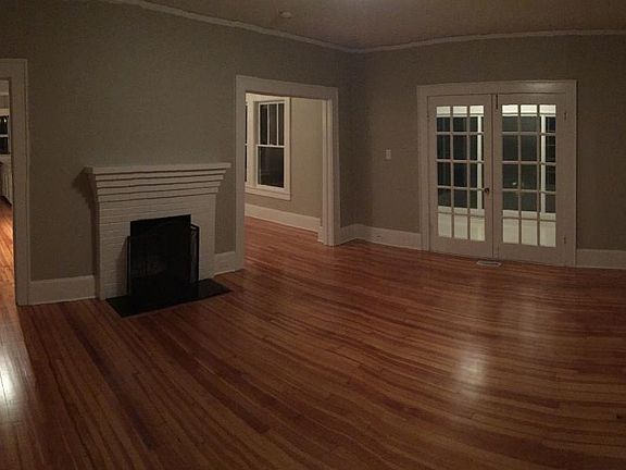 Living room in front of house, lower level. French doors lea