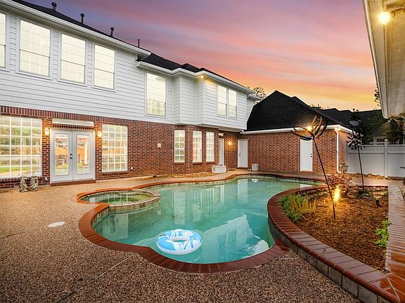 A view of the home at twilight, imagine the happy memories your family will make in this fabulous backyard.