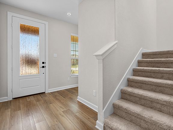 The entryway is highlighted by this gorgeous 3 4 lite door!