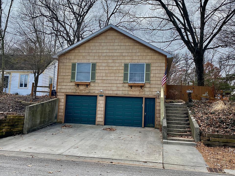 Stairs from the side go to the front door that opens in the living room. There is access to the house from garage as well