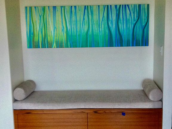 Guest room has a built in Murphy bed, sitting bench with storage and closet