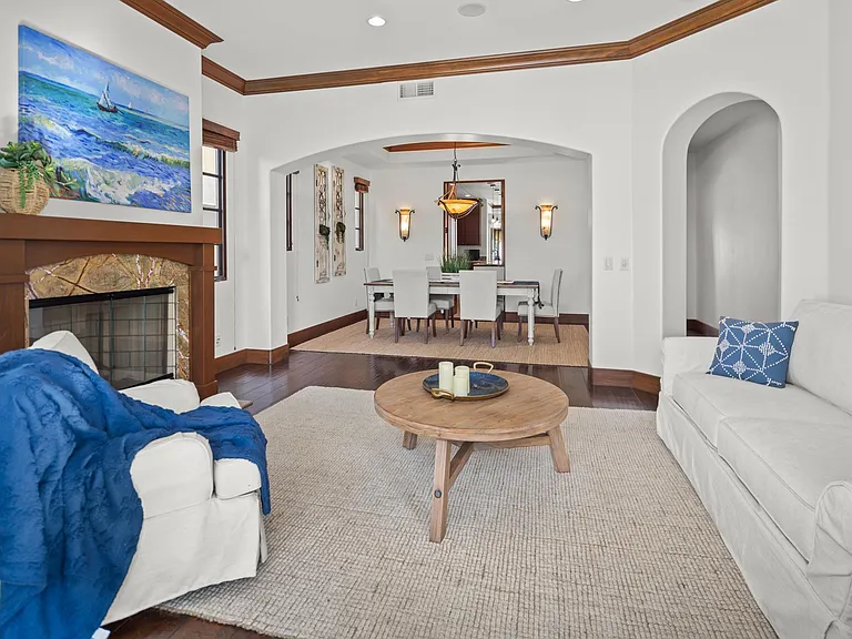 Formal living room with fireplace and invisible doors out to front porch / fire pit area