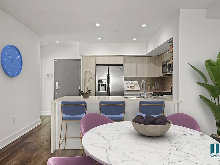 Front Entrance and Open-Concept Kitchen with Countertop Bar