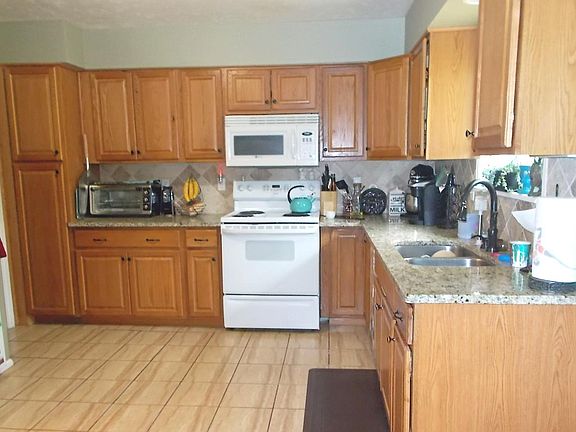 Granite countertops, ceramic tile.  Half bath off kitchen 