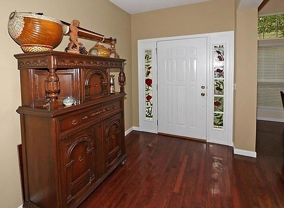 The entry door with stained glass sidelights welcomes you to this villa.