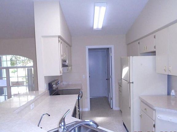 Kitchen opens up to living and dining areas.