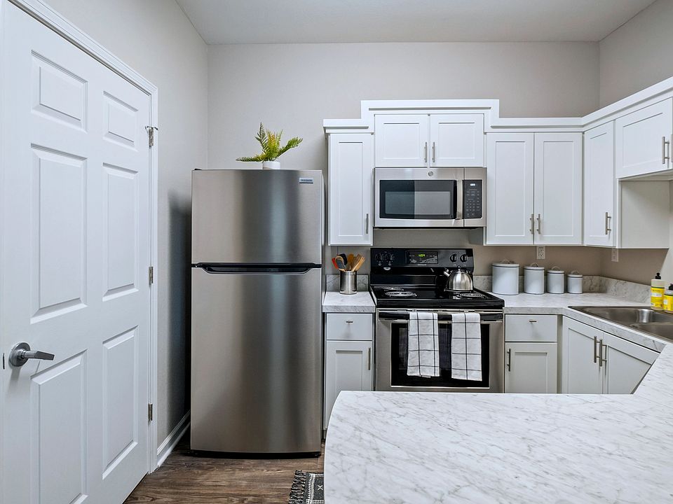 Fall in love with the newly remodeled kitchen, where stunning white marble-inspired countertops create a magical ambiance for your culinary adventures and a breakfast bar that opens to the living space for full enjoyment.