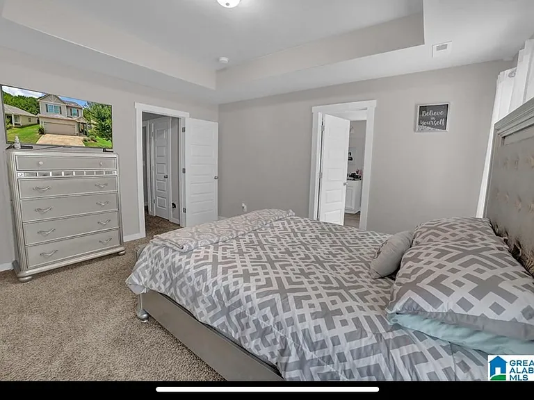 Master bedroom with entry to master bathroom