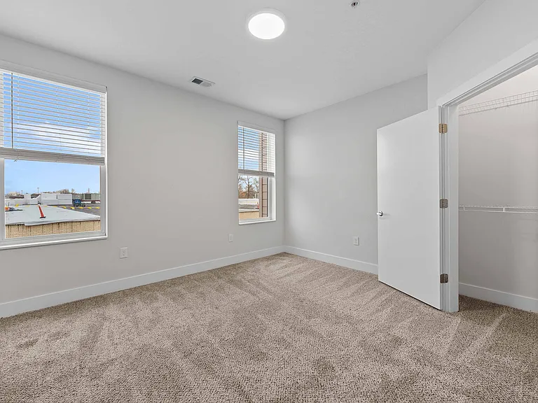 Bedroom with Walk-In Closet and Natural Light Bedroom with Walk-In Closet and Natural Light