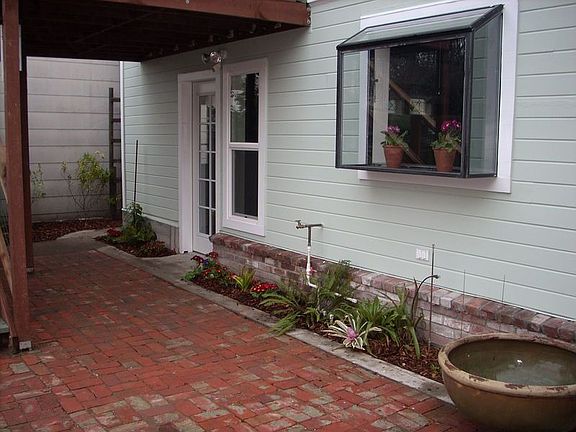 Backyard includes recycled brick patio
