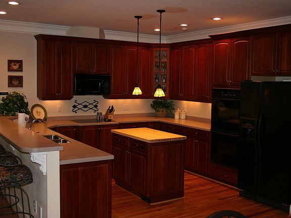 Kitchen with cherry cabinets, double oven, trash compactor, open to family rm