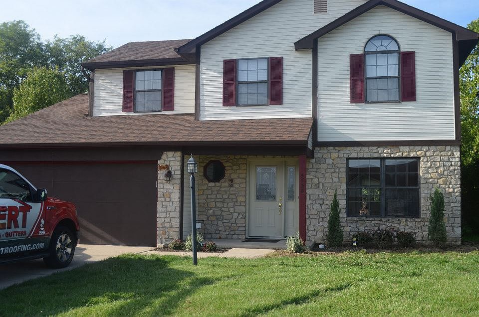 Two story traditional home with stone and siding finish. 