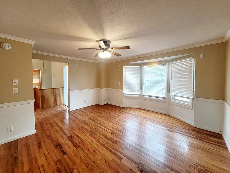 Living room with access to front entry mud room and dining area/kitchen