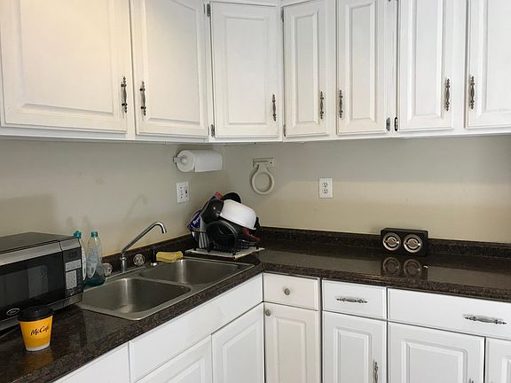 Kitchen has lots of cabinets and large area for kitchen table