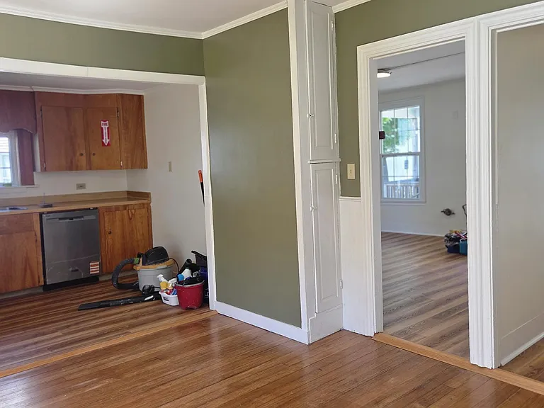 Dining Room View Leading Into Kitchen, Hallway and Living Area
