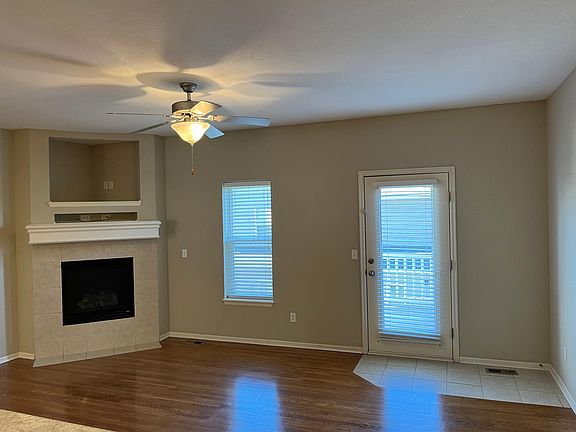 Living Room area with cozy fireplace. Door leads to Deck area