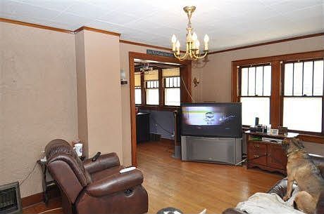The main living room area has lots of natural wood trim and hard wood floors.