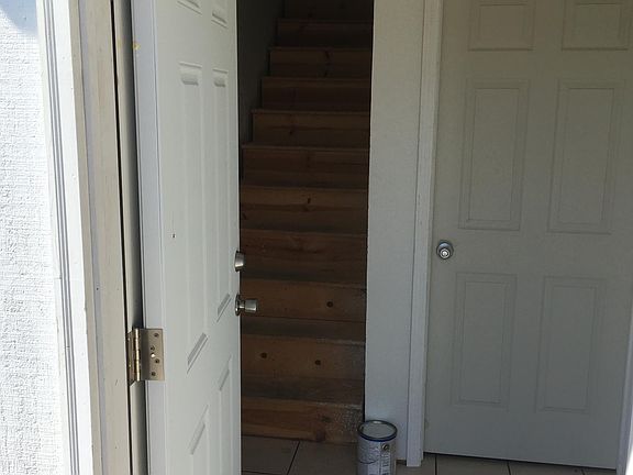 Entrance into basement hallway. Laundry on right. Step to