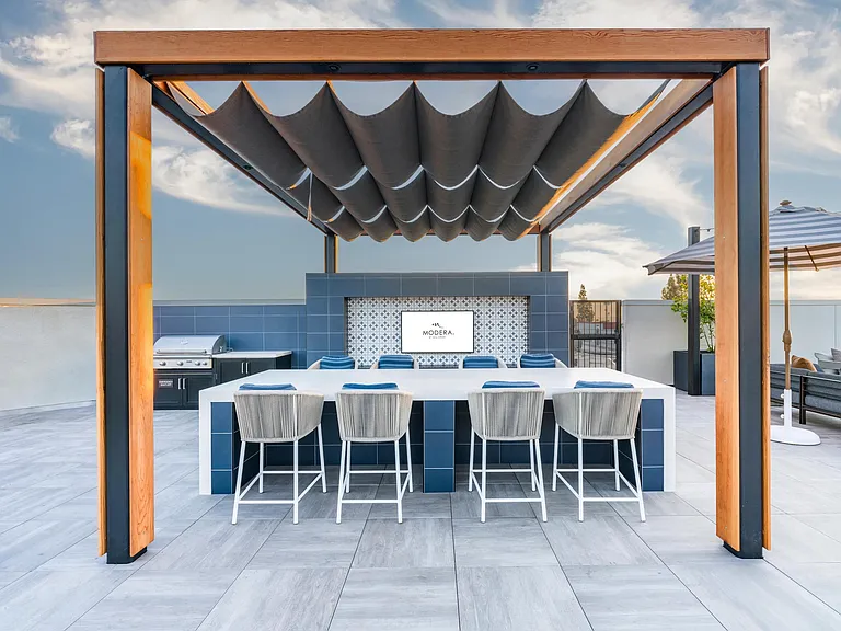 Resort-style pool at Modera Pomona with a relaxed lounge area, perfect for soaking up the sun and unwinding in style.