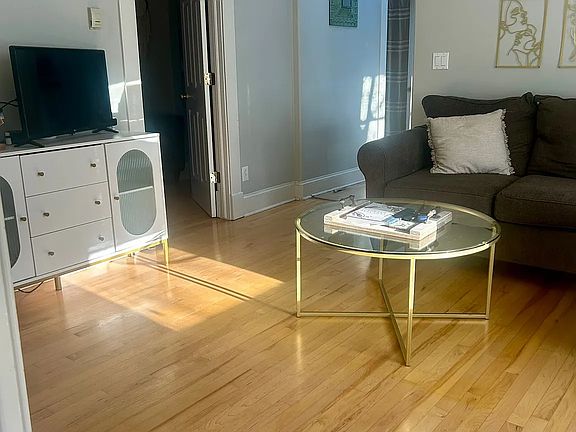 living room with middle bedroom door off to the left