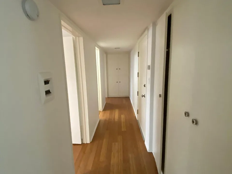Hallway with linen storage and half bath