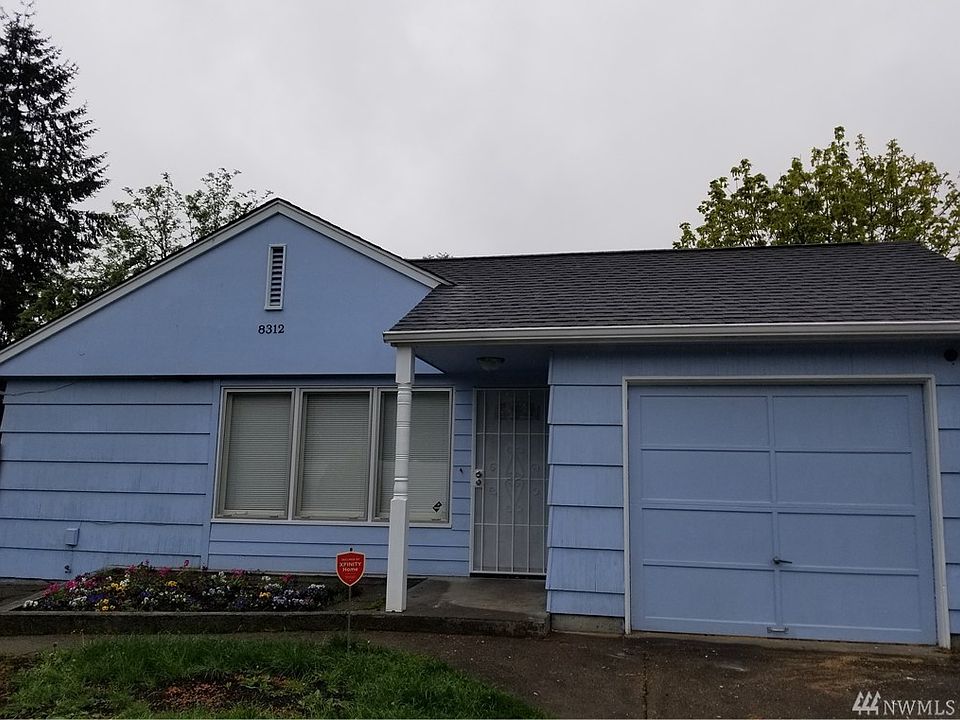 Near American Lake this cute cottage home sports 2 bdrms, 1 bath, 1 1/2 tandem garage, large fully fenced backyard, new interior paint, new bathroom,  fridge, doors, fruit trees, and more.  2 minutes from shops, restaurants, highway, JBLM, and school.