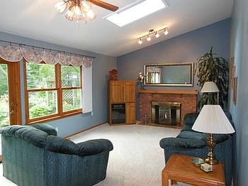 The family room with its vaulted ceilings and sky light are where this family spends most of their time.  It has generous windows facing the landscaped backyard and sliding doors which lead to one of the patios.  The fireplace is gas.