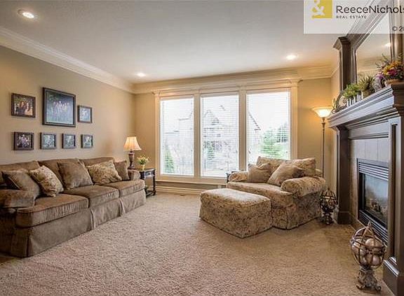 LARGE LIVING ROOM WITH FIREPLACE AND TONS OF NATURAL LIGHT
