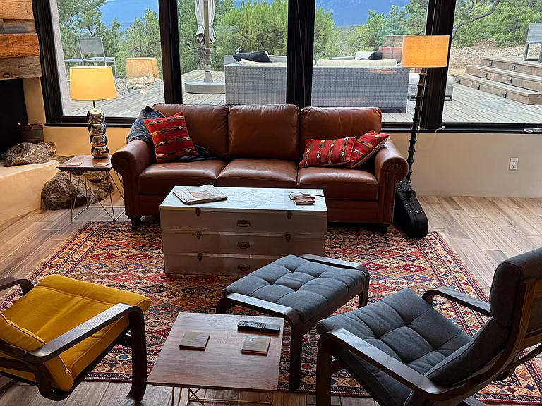 Living room with cozy leather couch and comfy lounge chairs