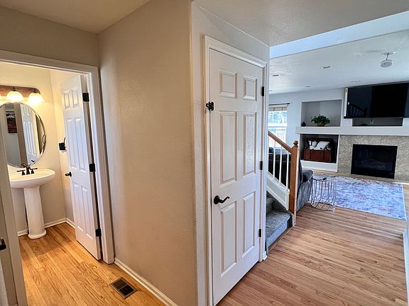 View as you step in from the front door. 1/2 bath and door to the basement seen right away.