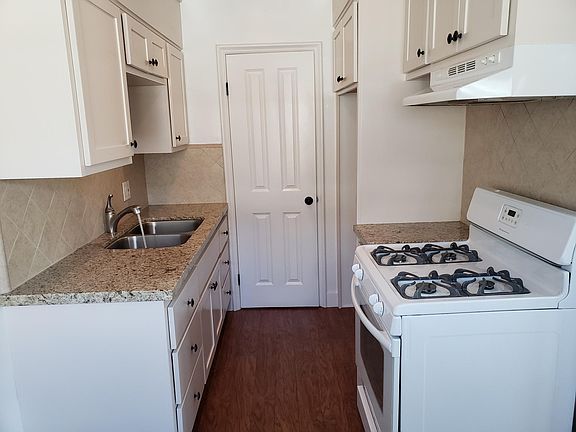 Remodeled Kitchen with new cabinets, granite counter, and gas range