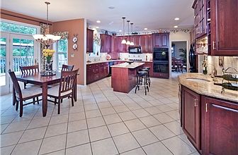 Upgraded gourmet kitchen has cherry cabinets.
