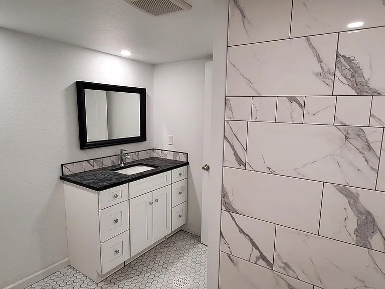 Downstairs bathroom with new vanity and custom tile