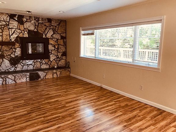 Main Living Area with Gas Fireplace, 
Casement Windows and White Faux Wood Blinds.