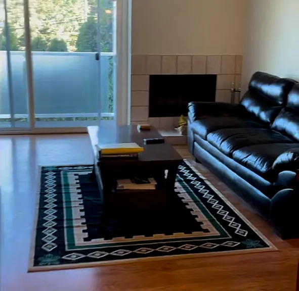 Living room opens to balcony. Sofa is not included.