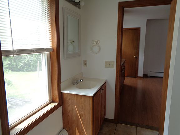Another view of bathroom off kitchen. Freshly painted last year. No additional wall mounted shelves/rods/hooks allowed.