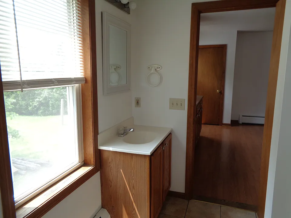 Another view of bathroom off kitchen. Freshly painted last year. No additional wall mounted shelves/rods/hooks allowed.