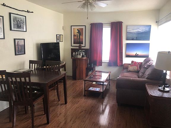 Living room - plenty of room for a large couch, coffee table, etc. Currently has kitchen/dining table in it as well.